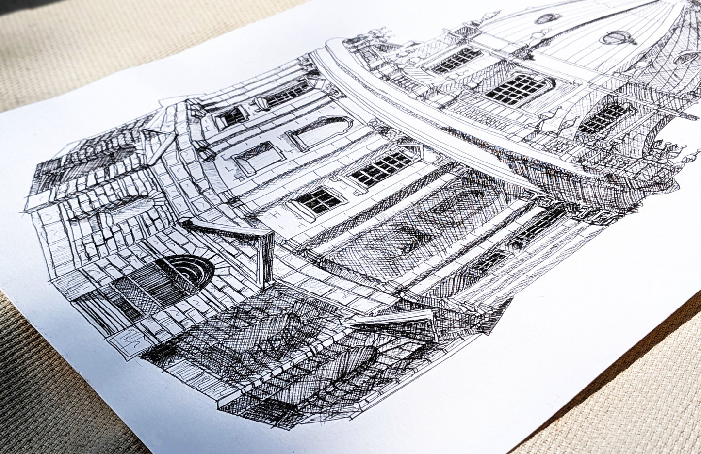 Detailed architectural drawing of a building on a white sheet of paper.