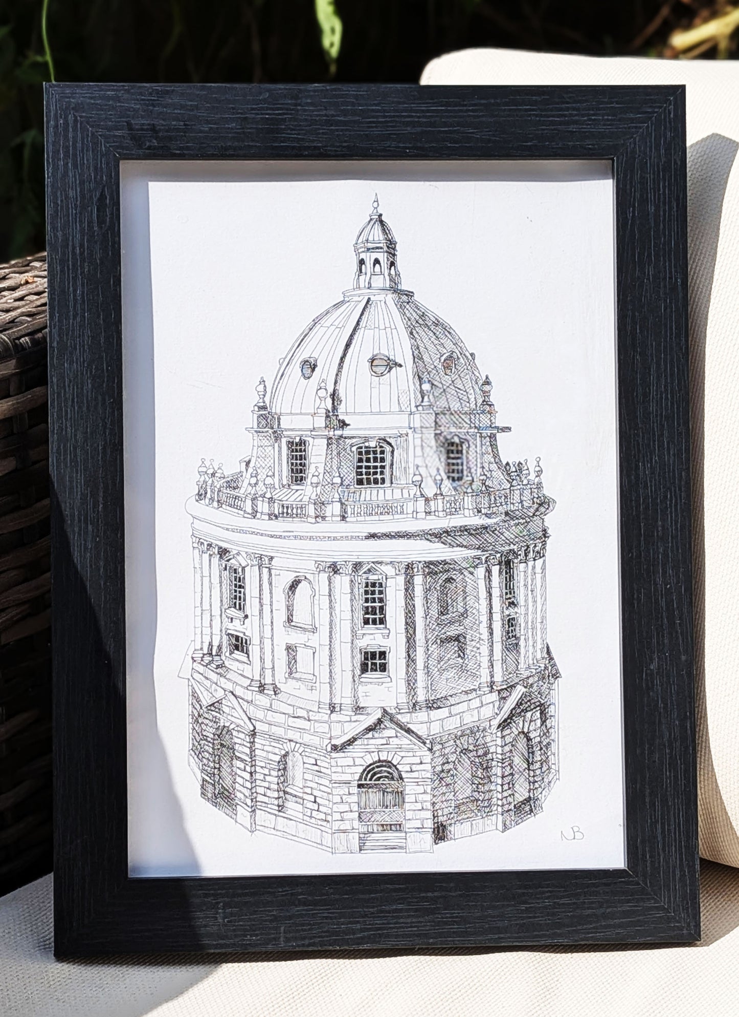 Framed black and white architectural drawing of a domed building