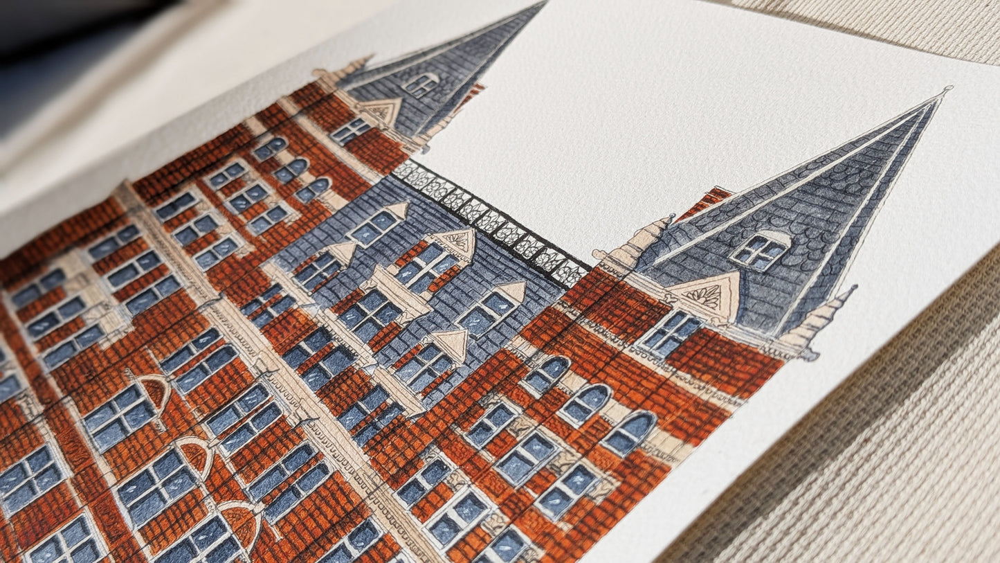 Close-up of a detailed embroidery of a building with red brick and gray roofs.