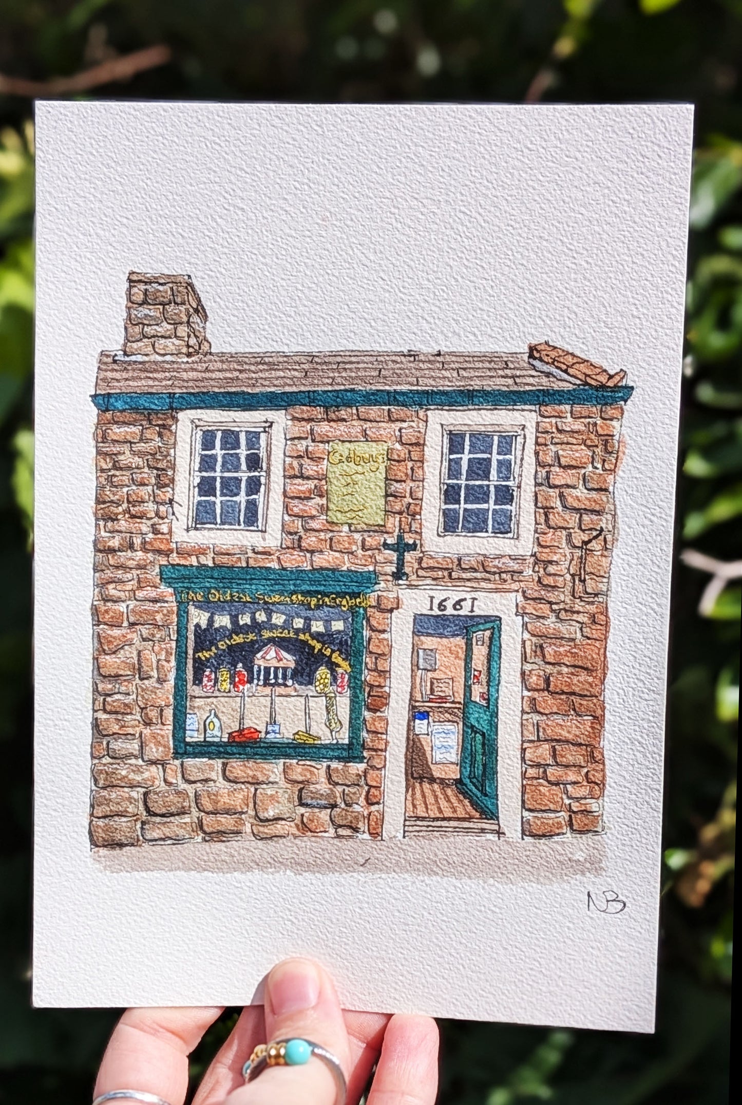 Illustration of a stone building with a shop front held against a natural background