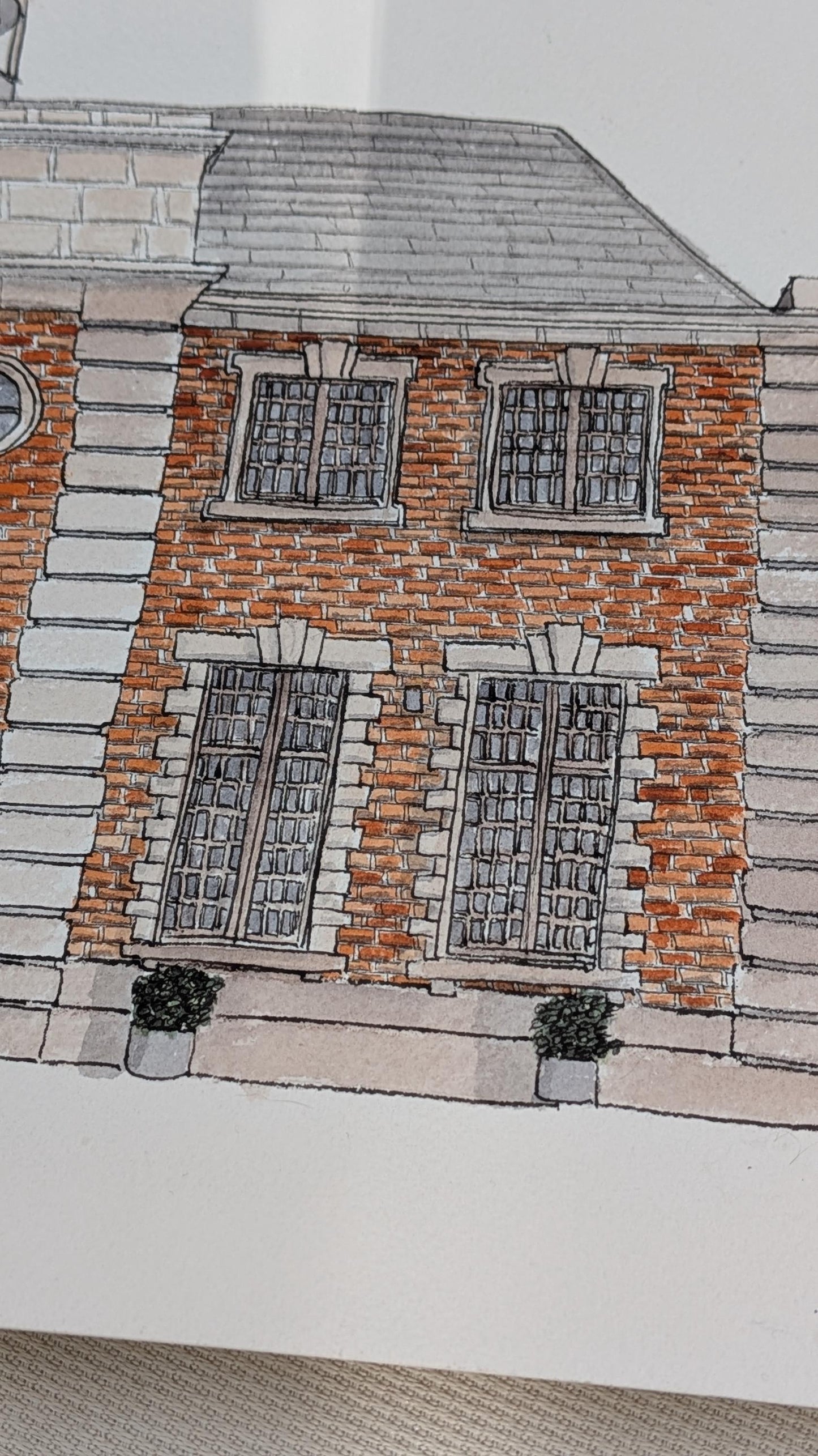 a watercolour painting of a large red brick wedding venue