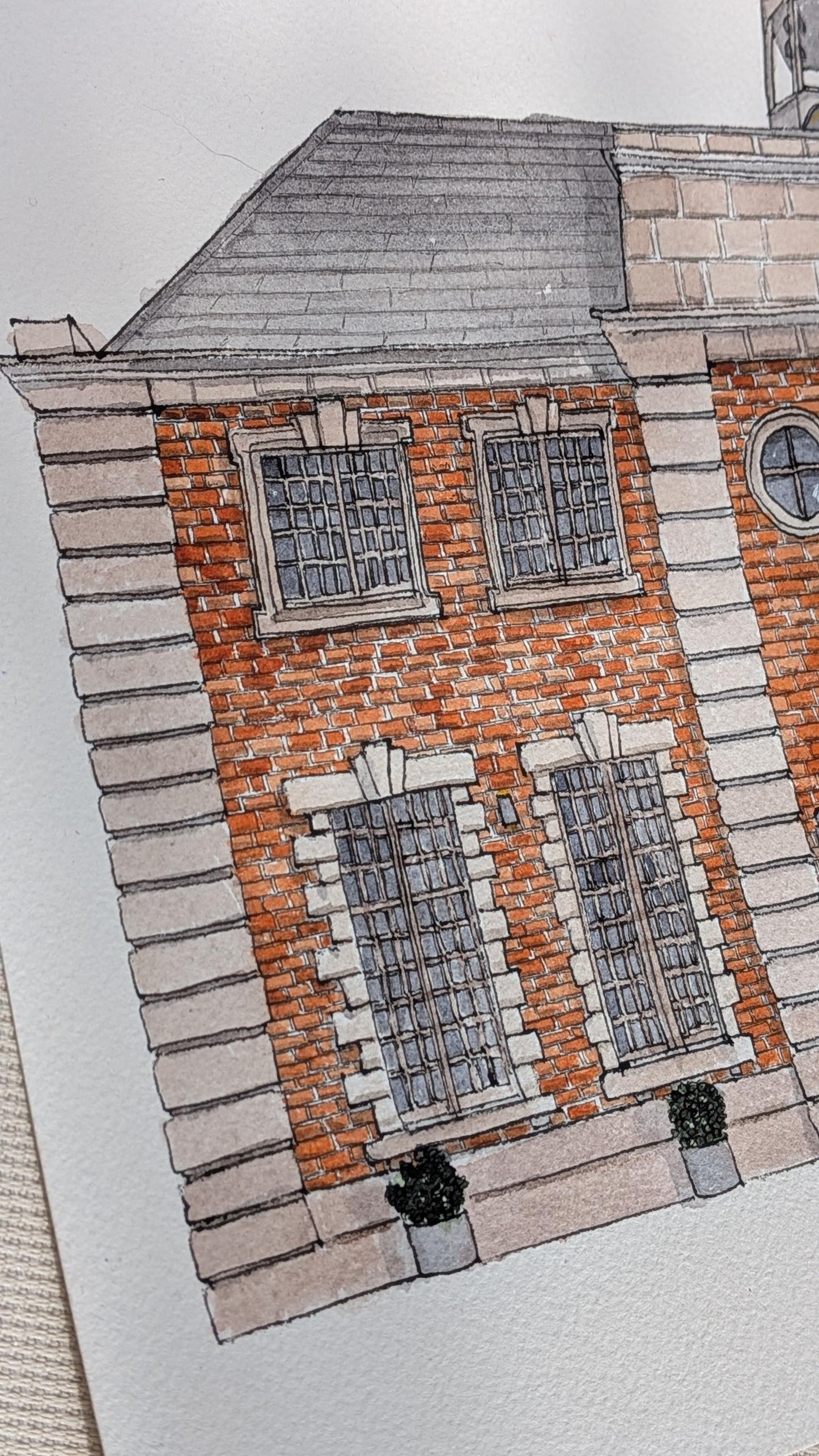 a watercolour painting of a large red brick wedding venue
