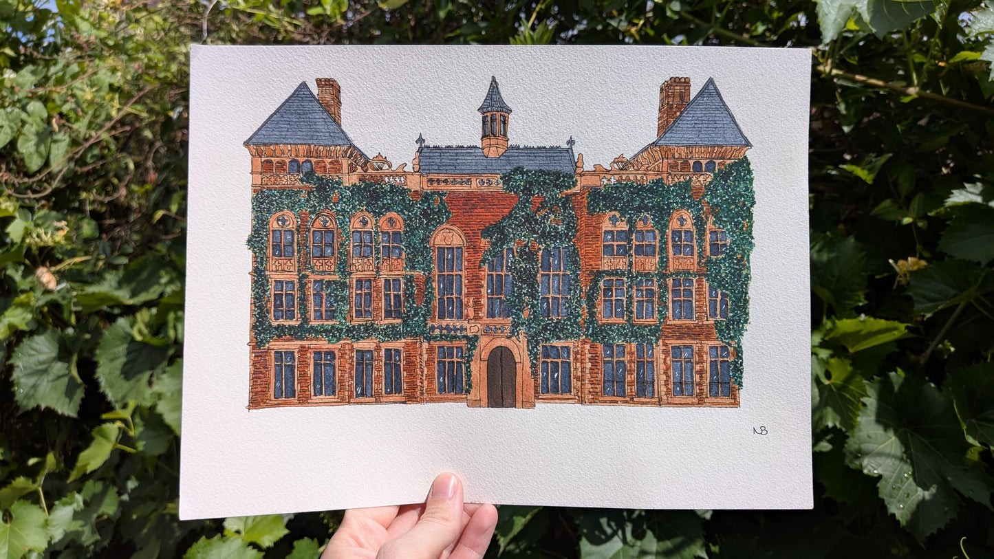 hand holding a watercolour painting of a large red bricked wedding venue covered in Ivy