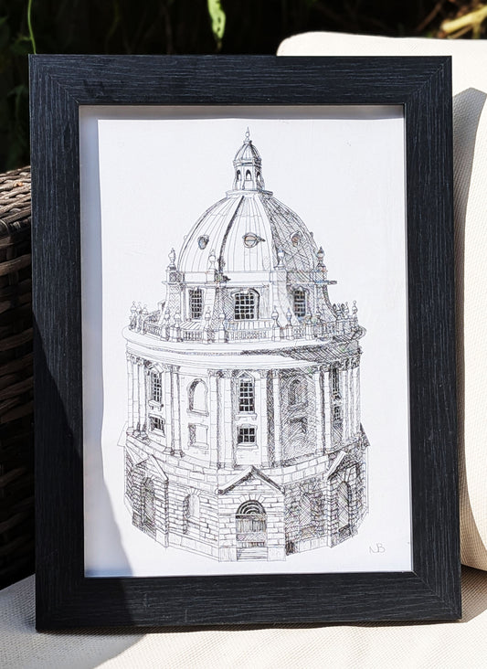 Framed black and white architectural drawing of a domed building