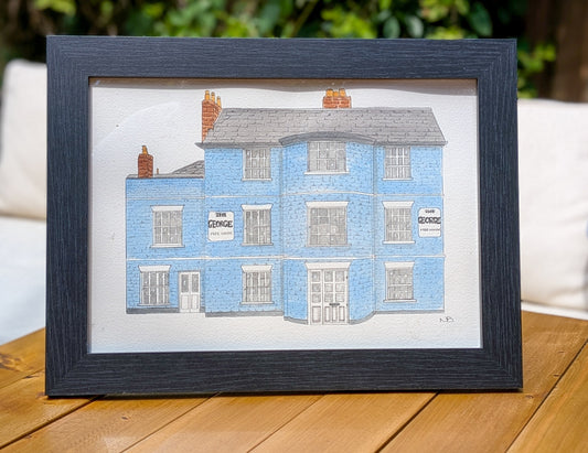 Hand-painted watercolour painting of The George pub, Tunbridge Wells, featuring blue walls and detailed architectural elements, displayed in a black frame.
