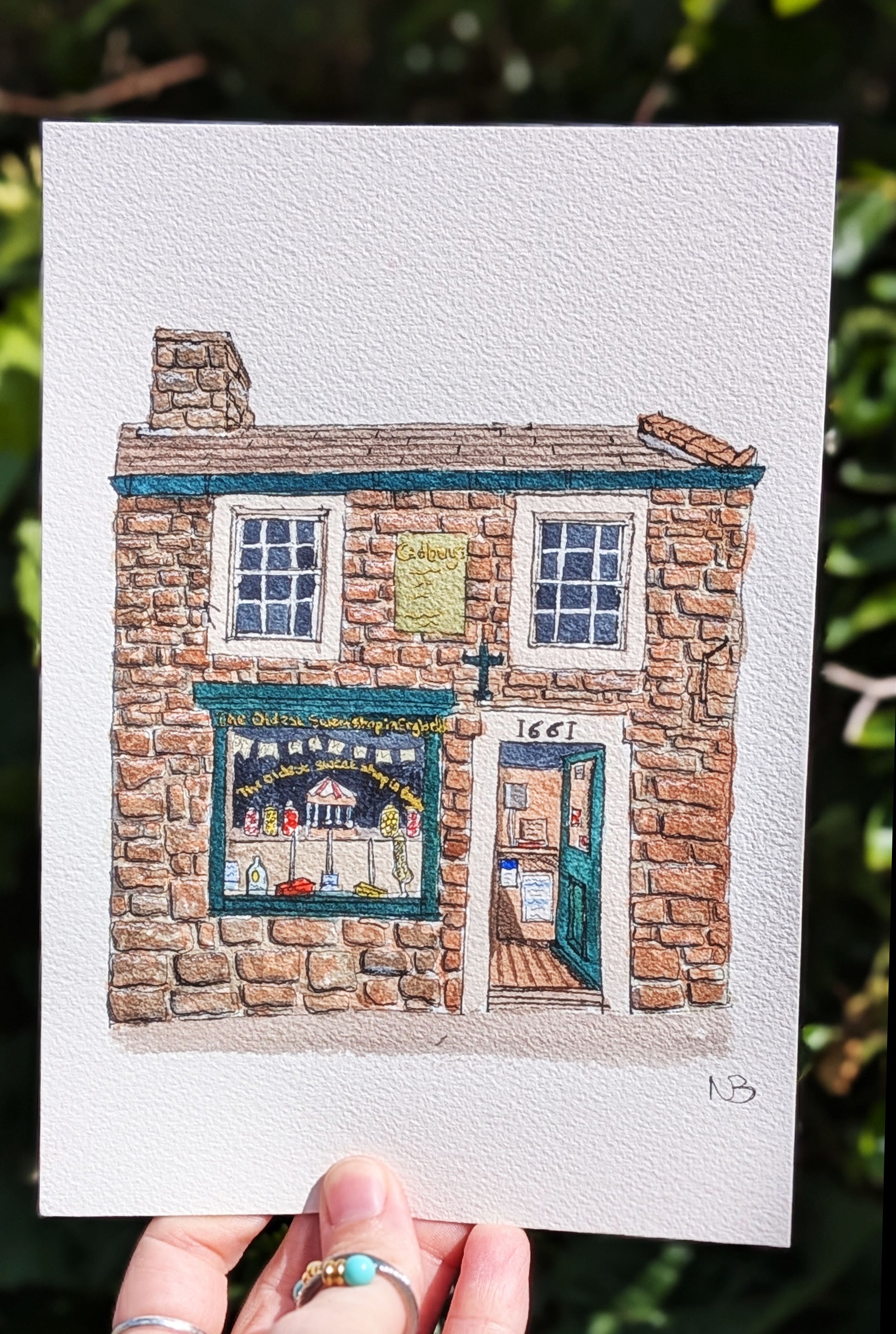 Illustration of a stone building with a shop front held against a natural background