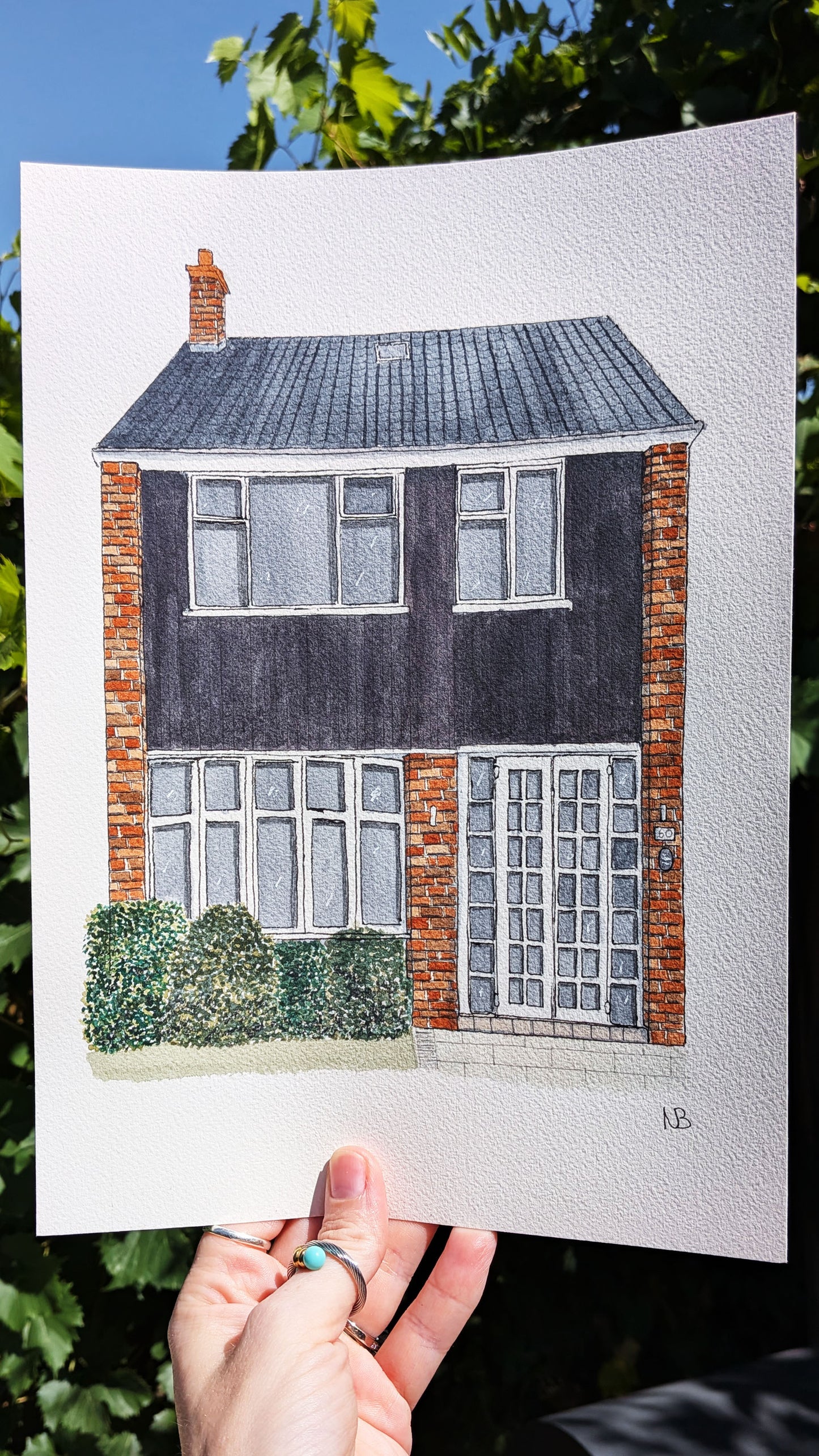 hand painted watercolour painting of a red bricked and black panelled home
