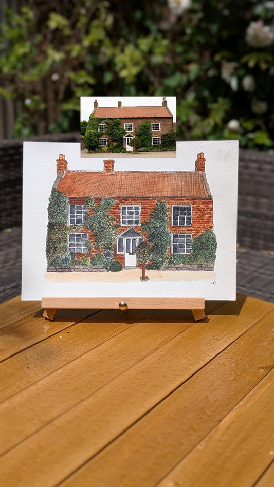 watercolour painting of a red bricked wedding venue with the reference photo above