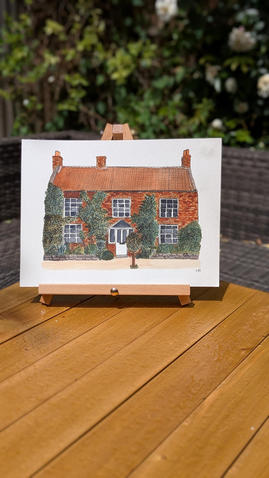watercolour painting of a red bricked wedding venue 