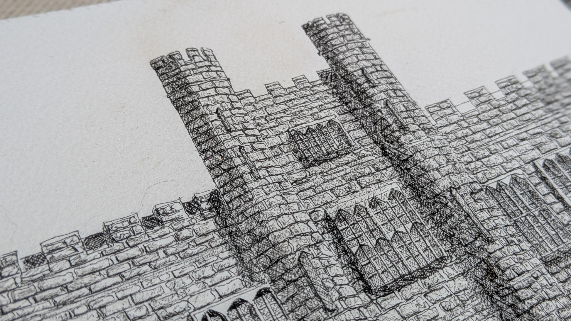 Close-up of a detailed stone wall drawing on paper